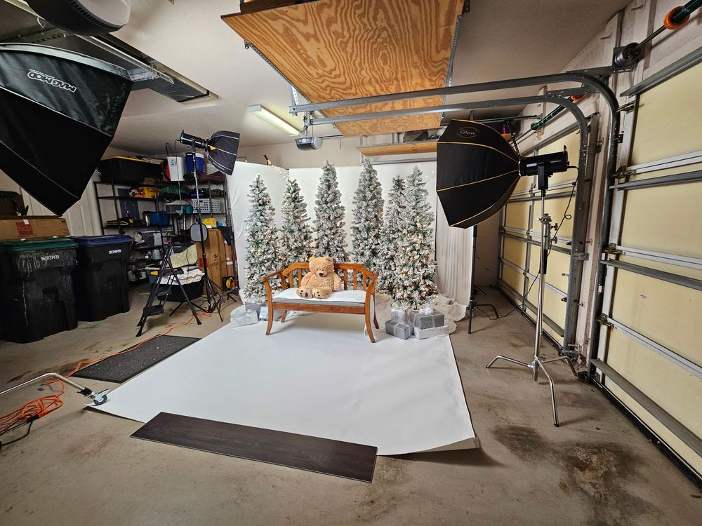 A panoramic view of a large empty garage interior with wood ceiling panels and concrete floor.