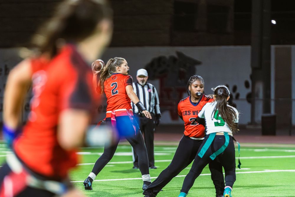 Girls flag football quarterback mid throw