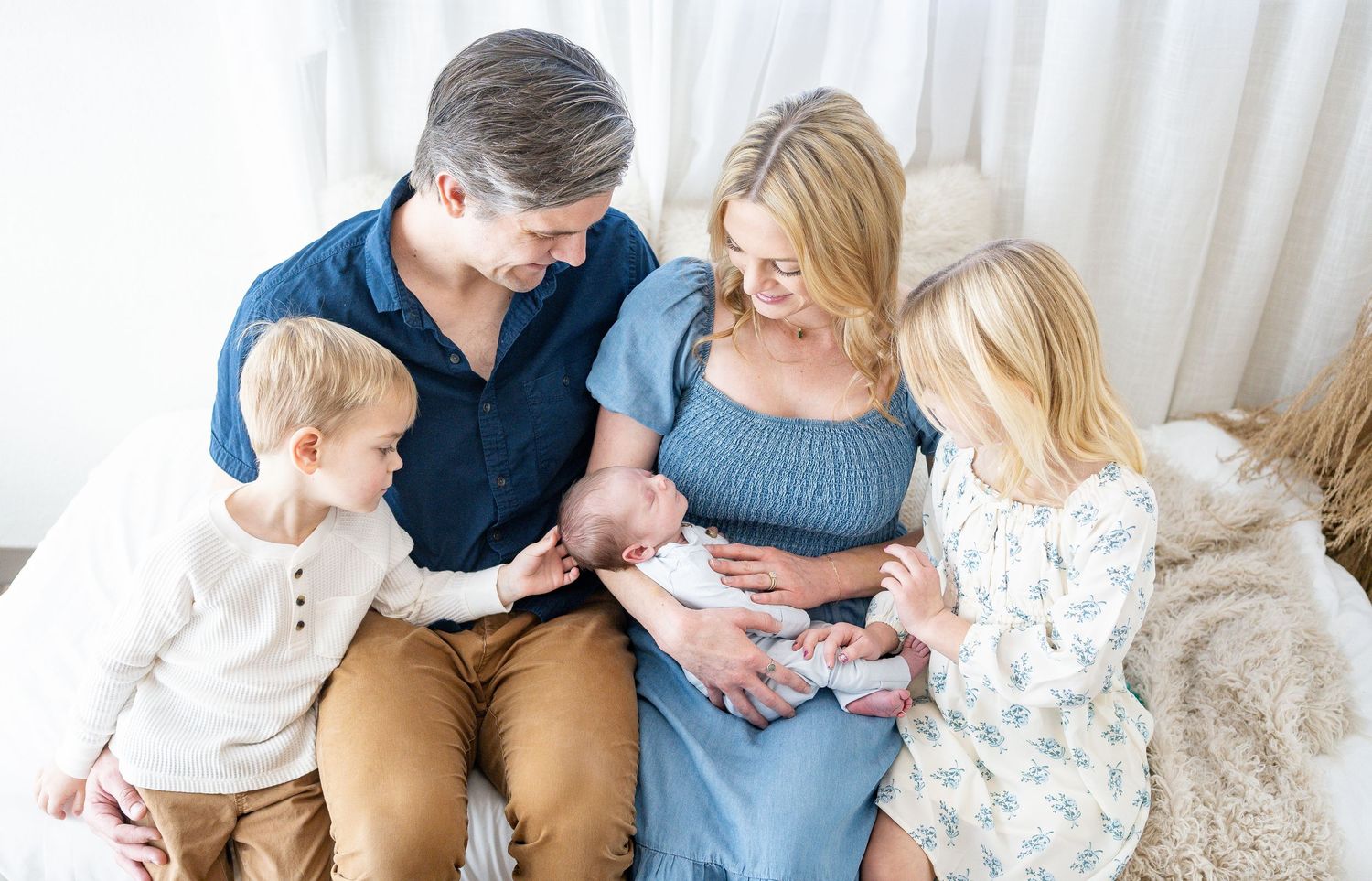 A series of candid lifestyle photos showing tender family moments on a cream-colored couch.