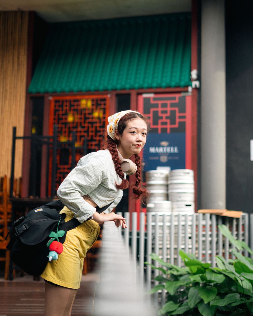 Casual street fashion look in front of traditional Asian architecture and decor.