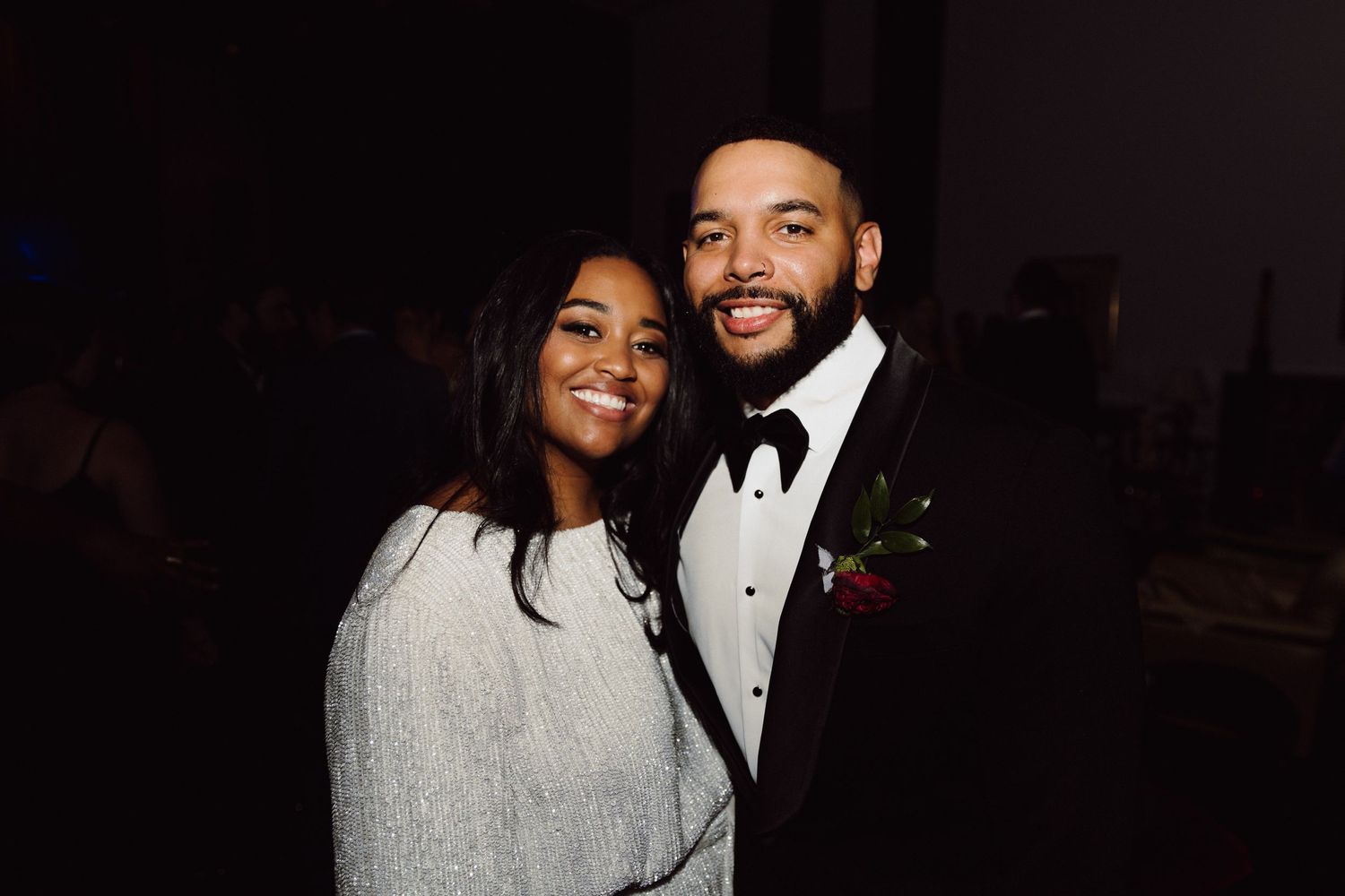 A couple in formal attire shares a romantic moment during their wedding celebration.