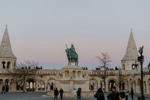 The Fisherman's Bastion in Budapest with its iconic white towers and equestrian statue at twilight.