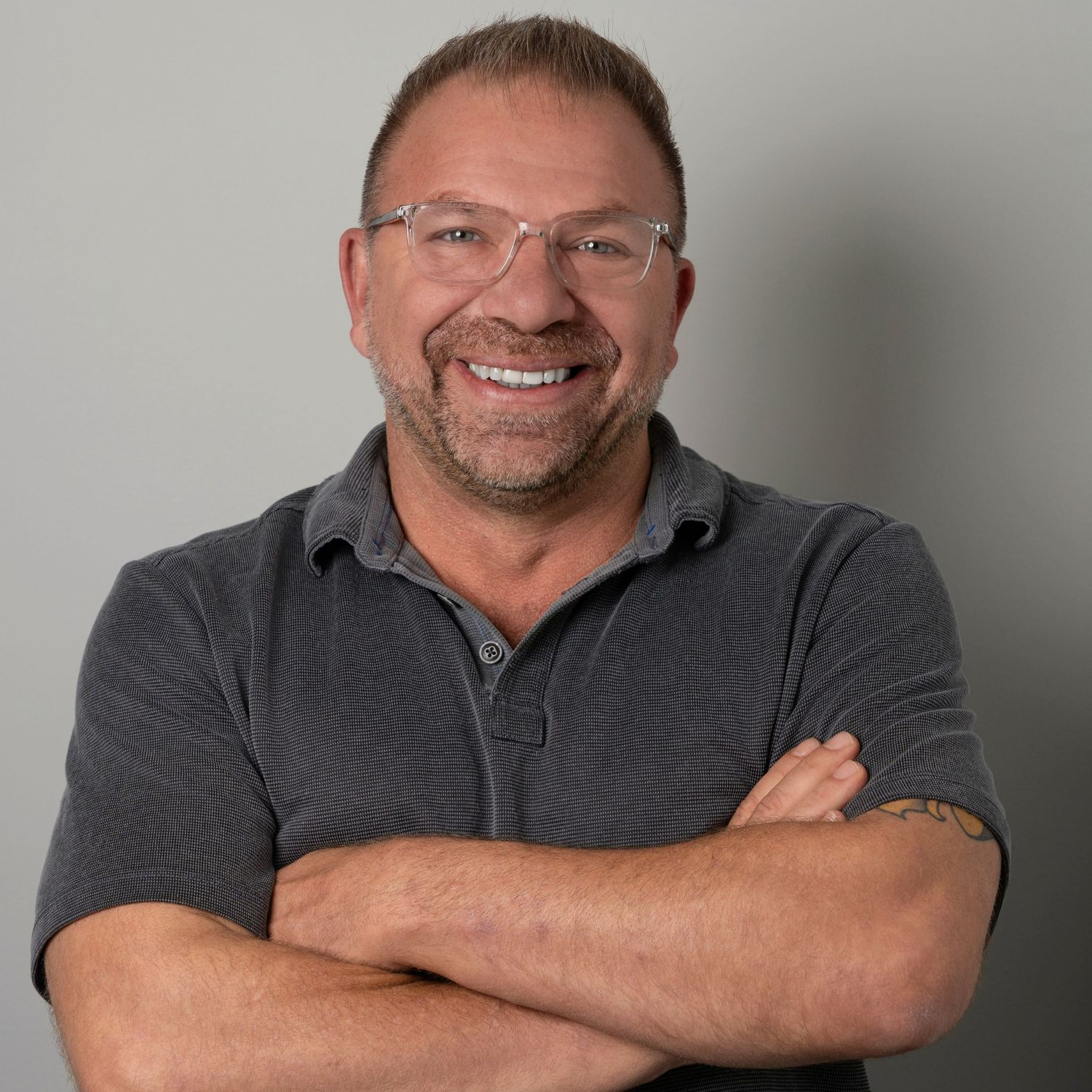 Portrait series of someone wearing a gray sweater showing various expressions against a neutral background.