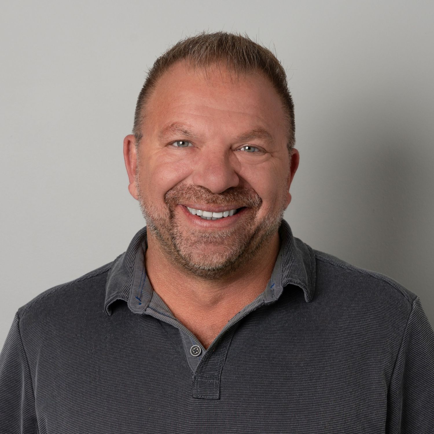 Person in a grey polo collar shirt shown from different angles looking at the camera with a friendly smile.