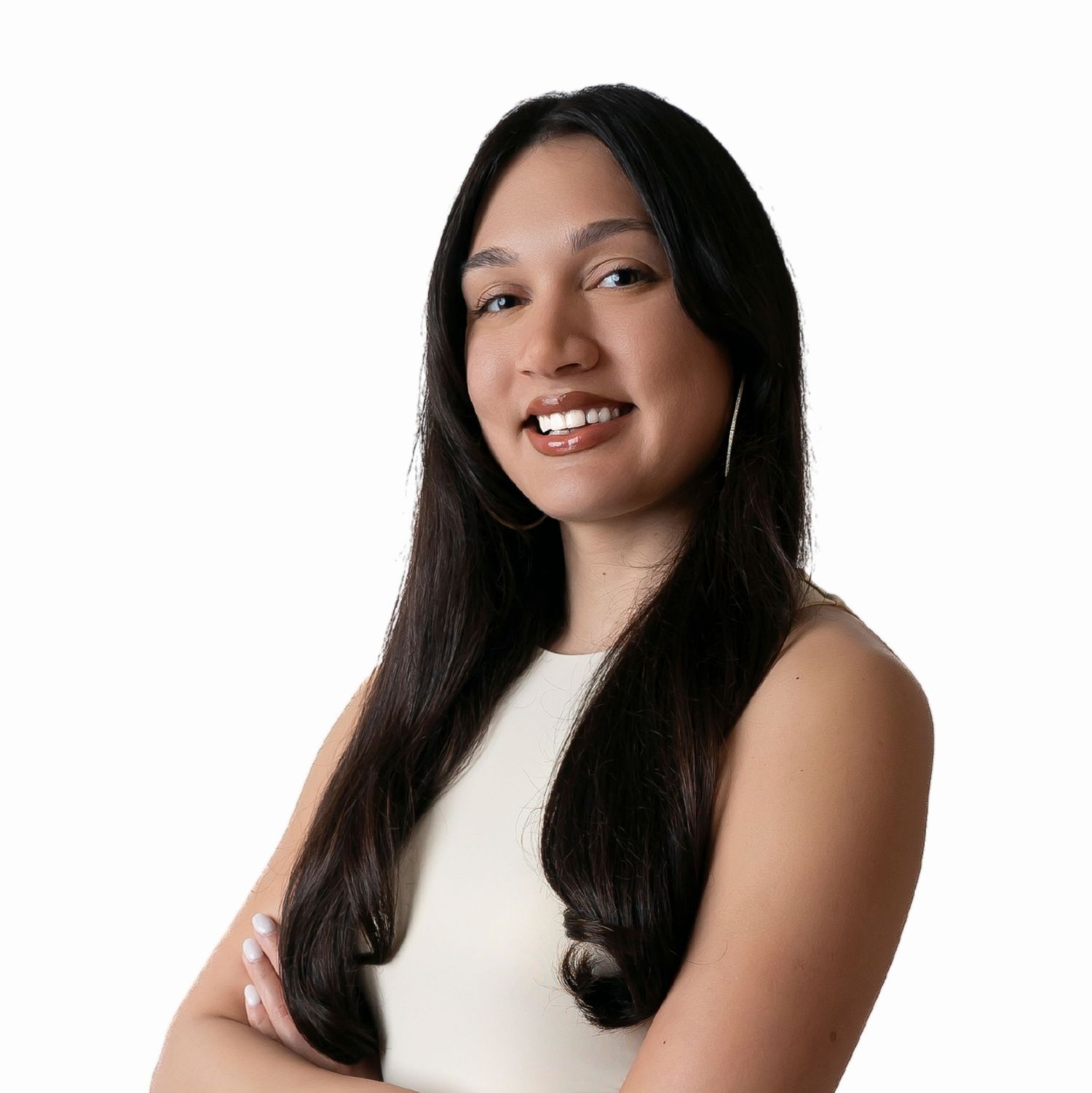 Professional headshot of a person in a sleeveless white top smiling warmly against a light background.