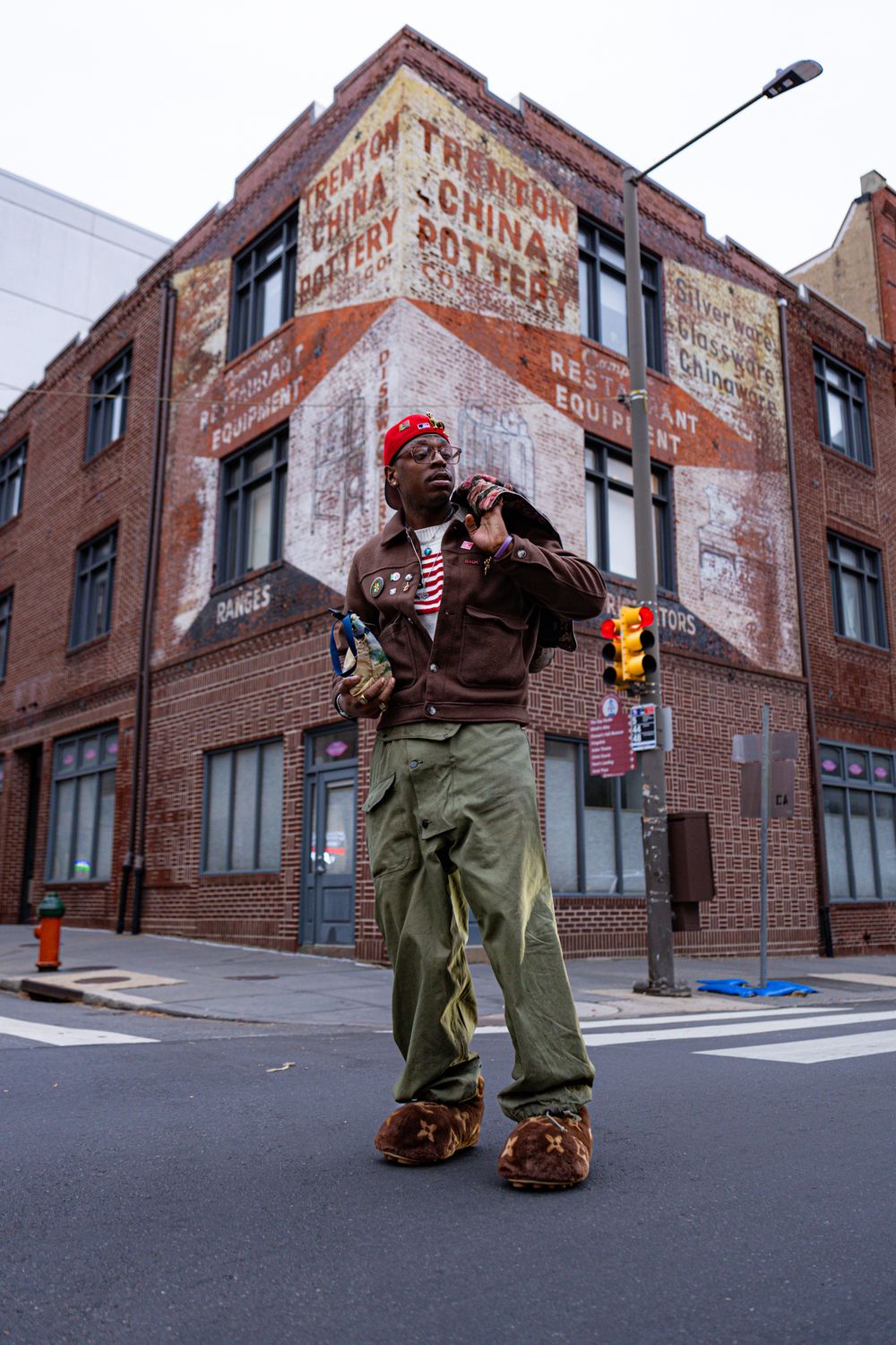 Urban street scene with brick buildings and faded painted signage on exterior walls.