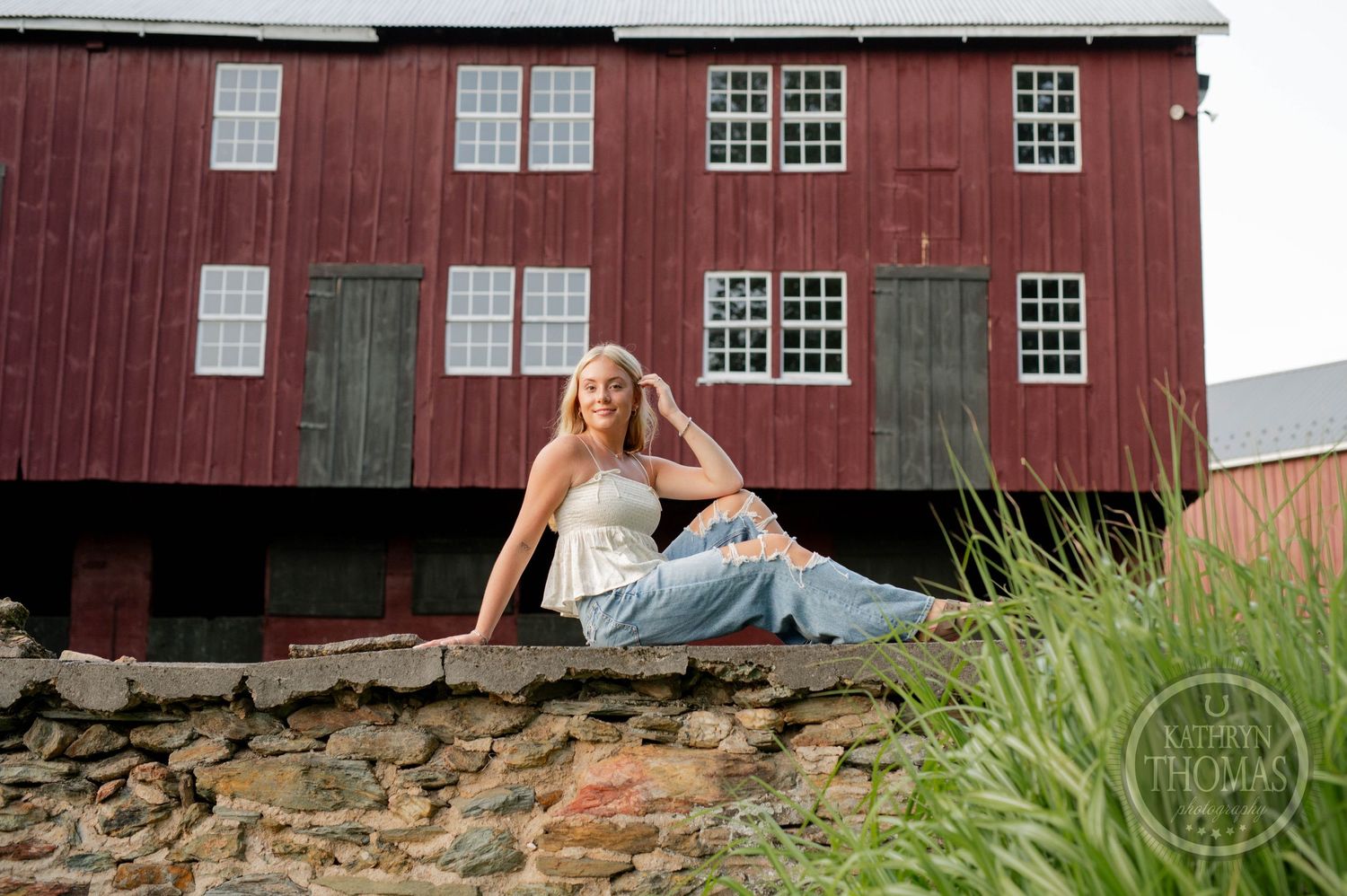 Country fashion shoot featuring rustic barn architecture and stone foundation.