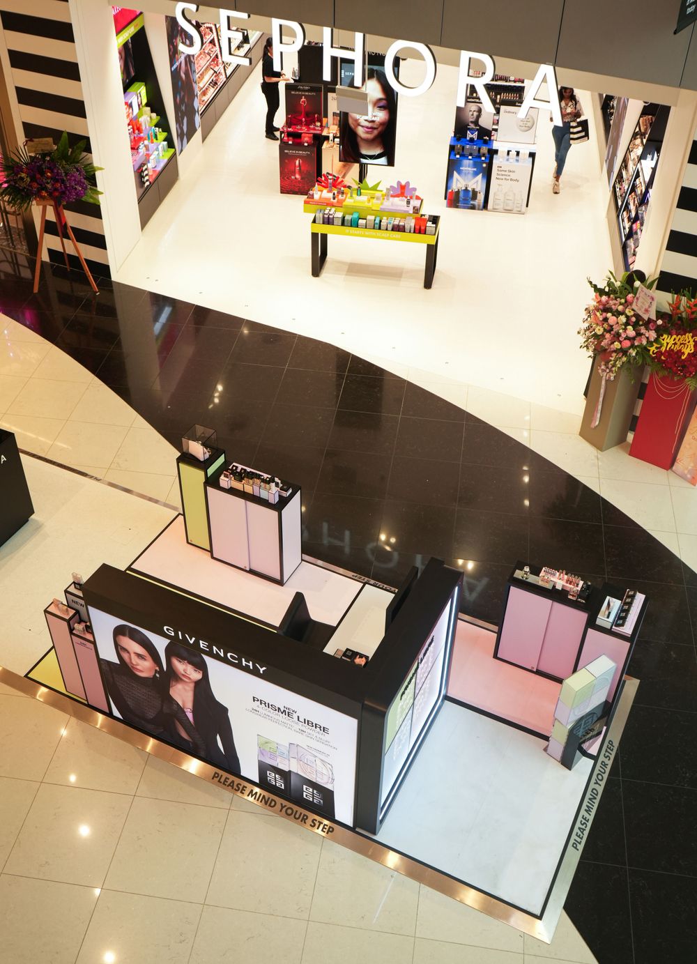 Elevated view of a Sephora retail display in a shopping mall with black and white striped branding.