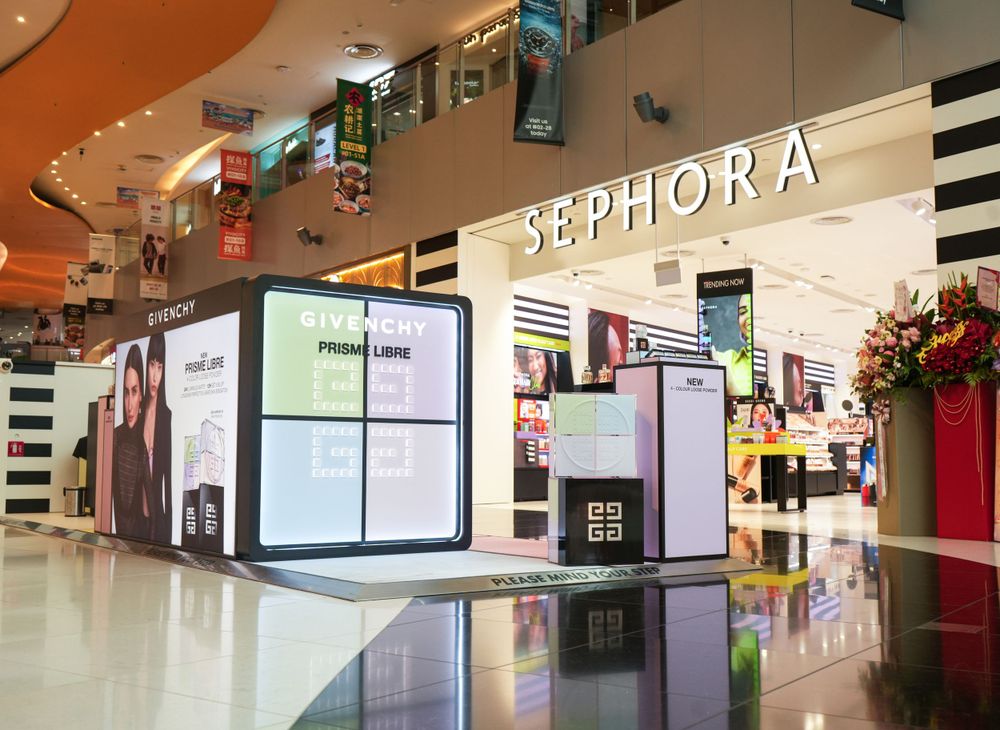 Sephora storefront with digital displays and modern retail fixtures in a bright mall setting.