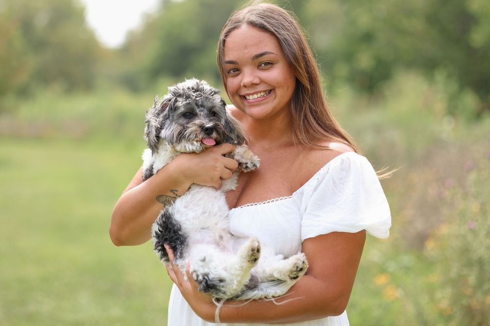 Springfield, IL family photographer captures a young woman with her dog during a session in Central, IL