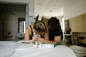 Birth photography in Karratha. A husband comforts his wife while she is in labour