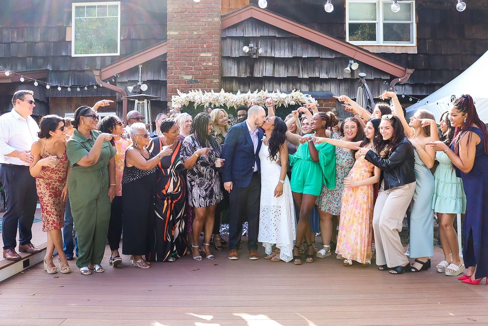 Large group of guests celebrating together outdoors at a festive party event.