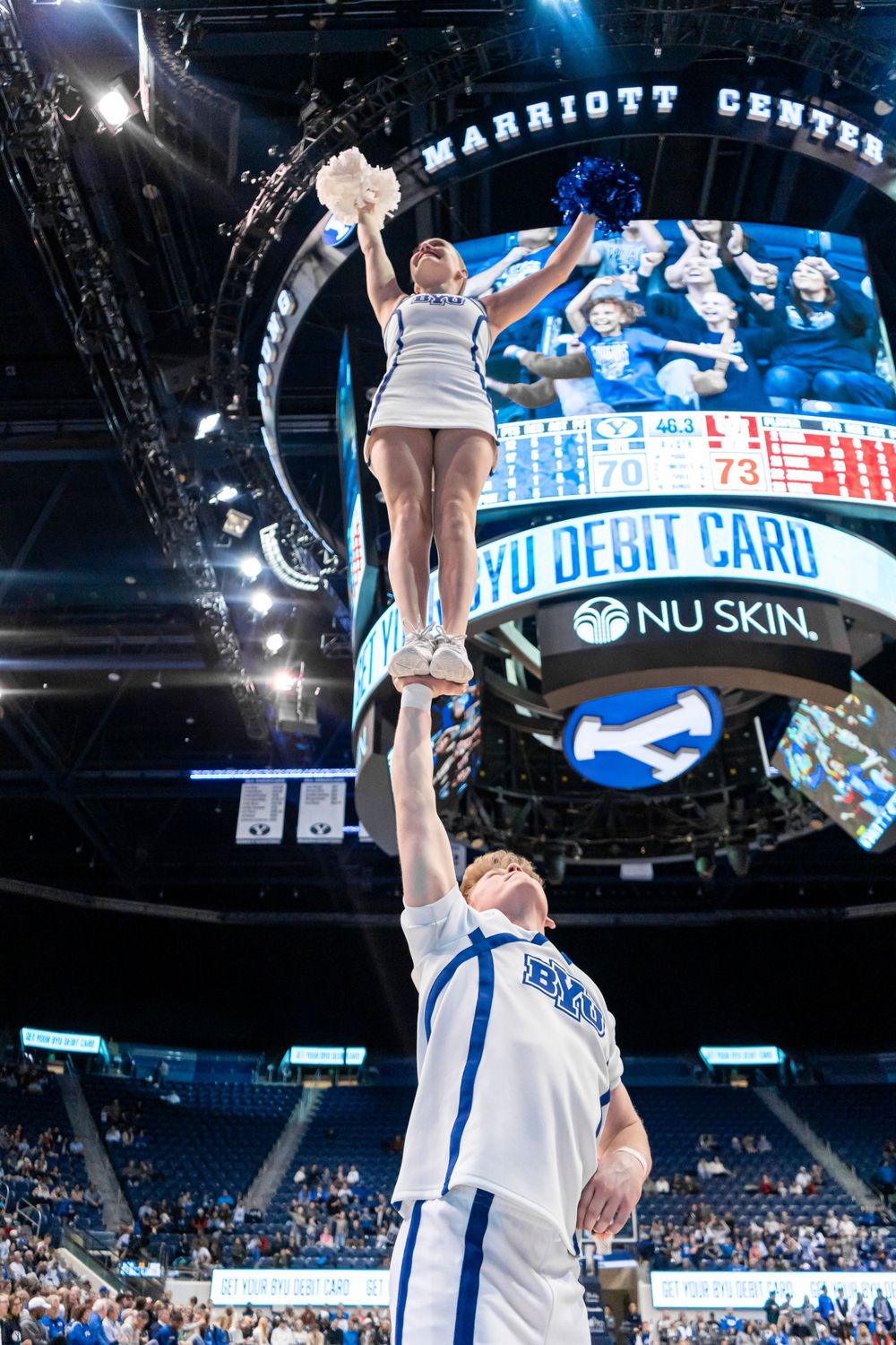 BYU cheerleaders in the air