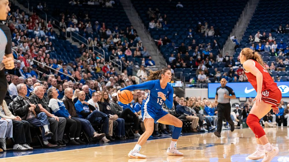 BYU Womens basketball player dribbling away from opponent