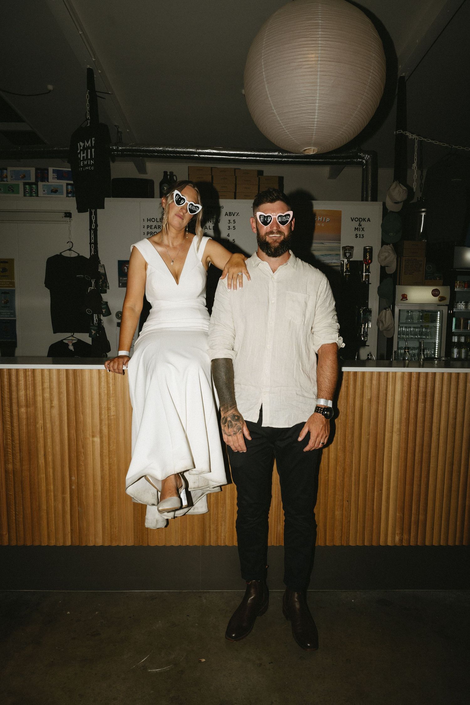 Party photos with white paper lanterns and wood paneled walls in dim lighting.