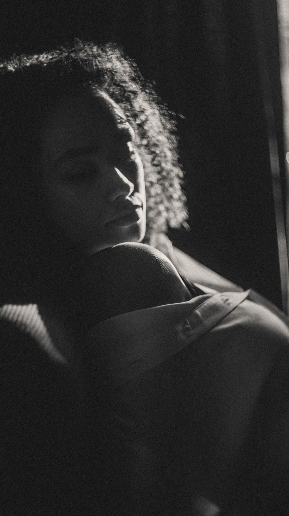 Artistic black and white portraits showing silhouette and backlit hair detail.