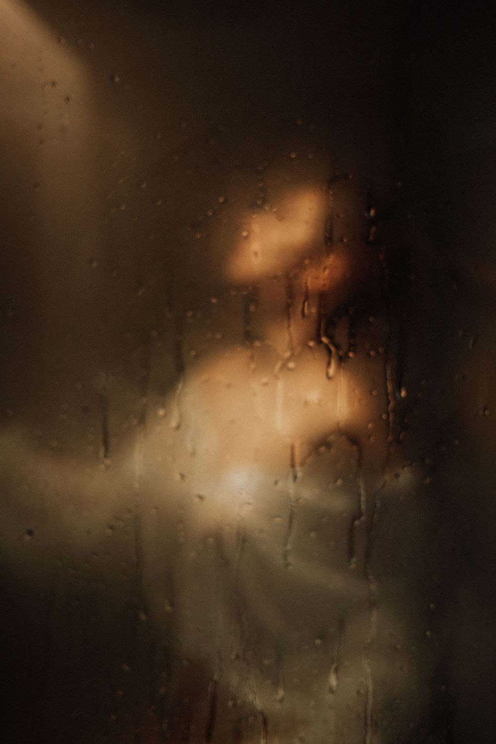 Abstract photography sequence showing light and shadows through rain-covered glass.