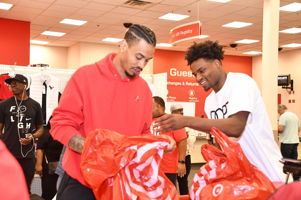 Two people examining items in red Target shopping bags.