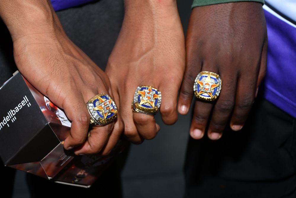 Display of multiple championship rings showing detailed craftsmanship and diamonds.