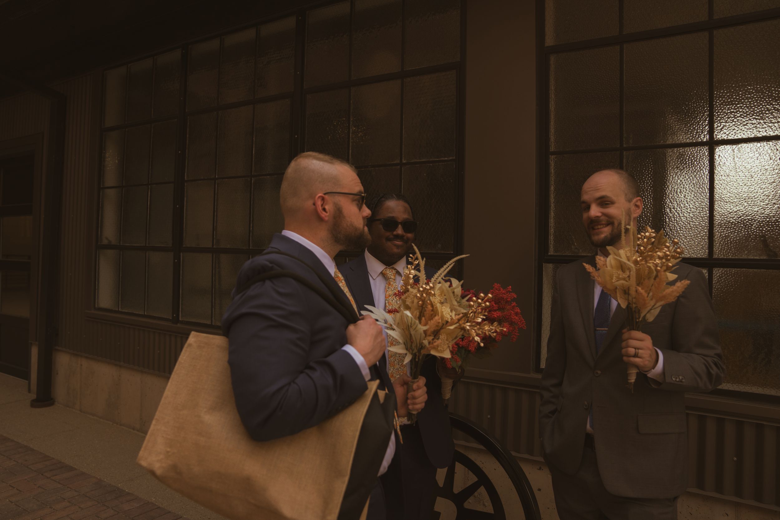Wedding guests gathered in a dimly lit indoor venue.