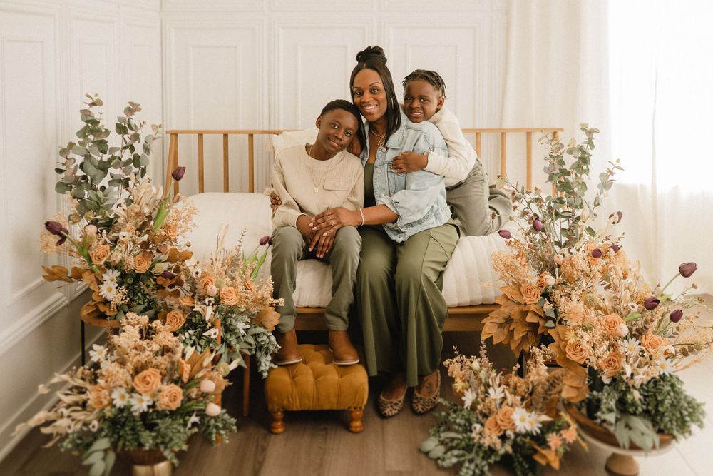 Interior scene with beautiful floral arrangements in peach and green tones decorating a cozy bench setting.