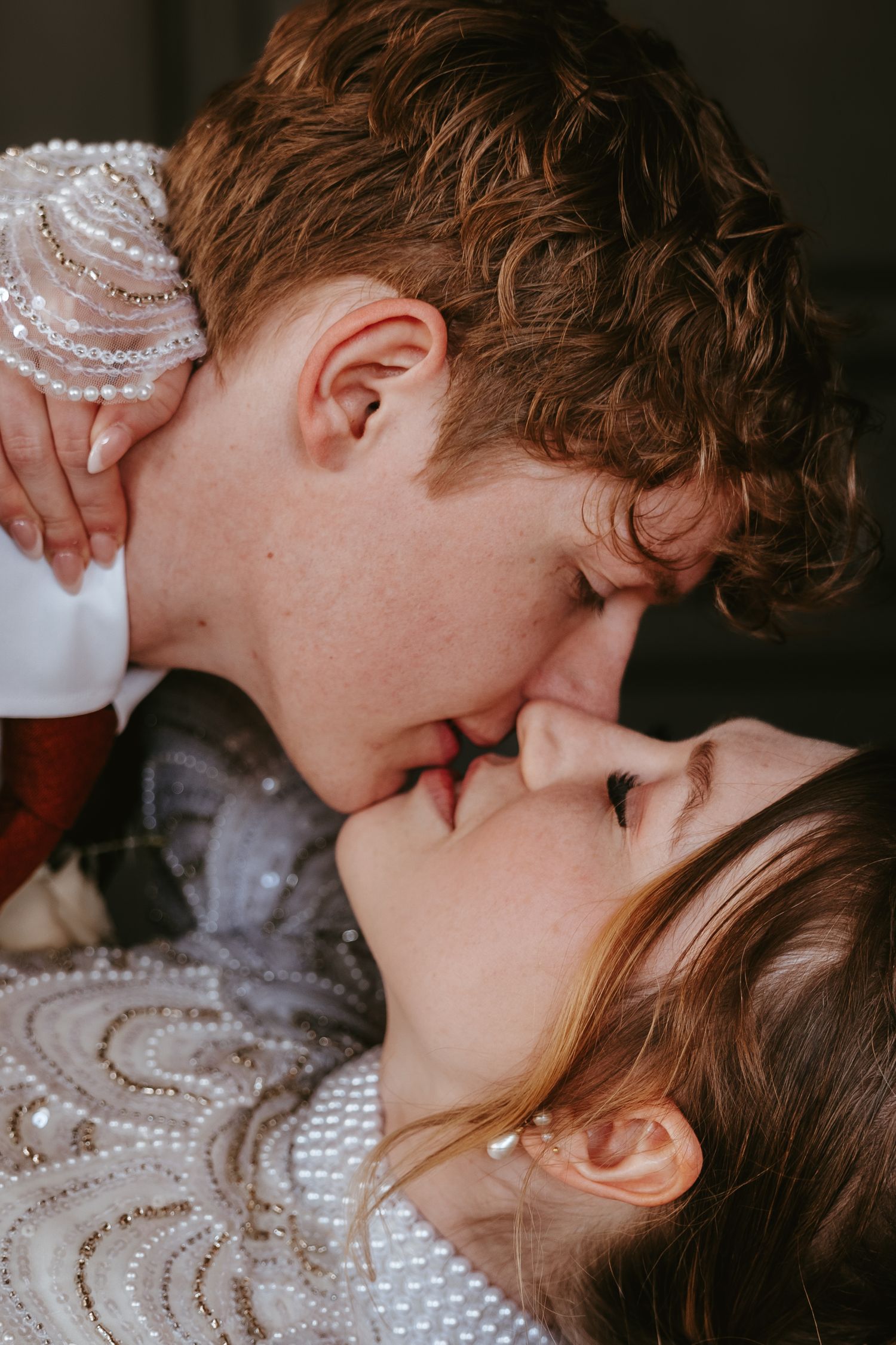 An intimate close-up wedding portrait capturing a tender moment between newlyweds.