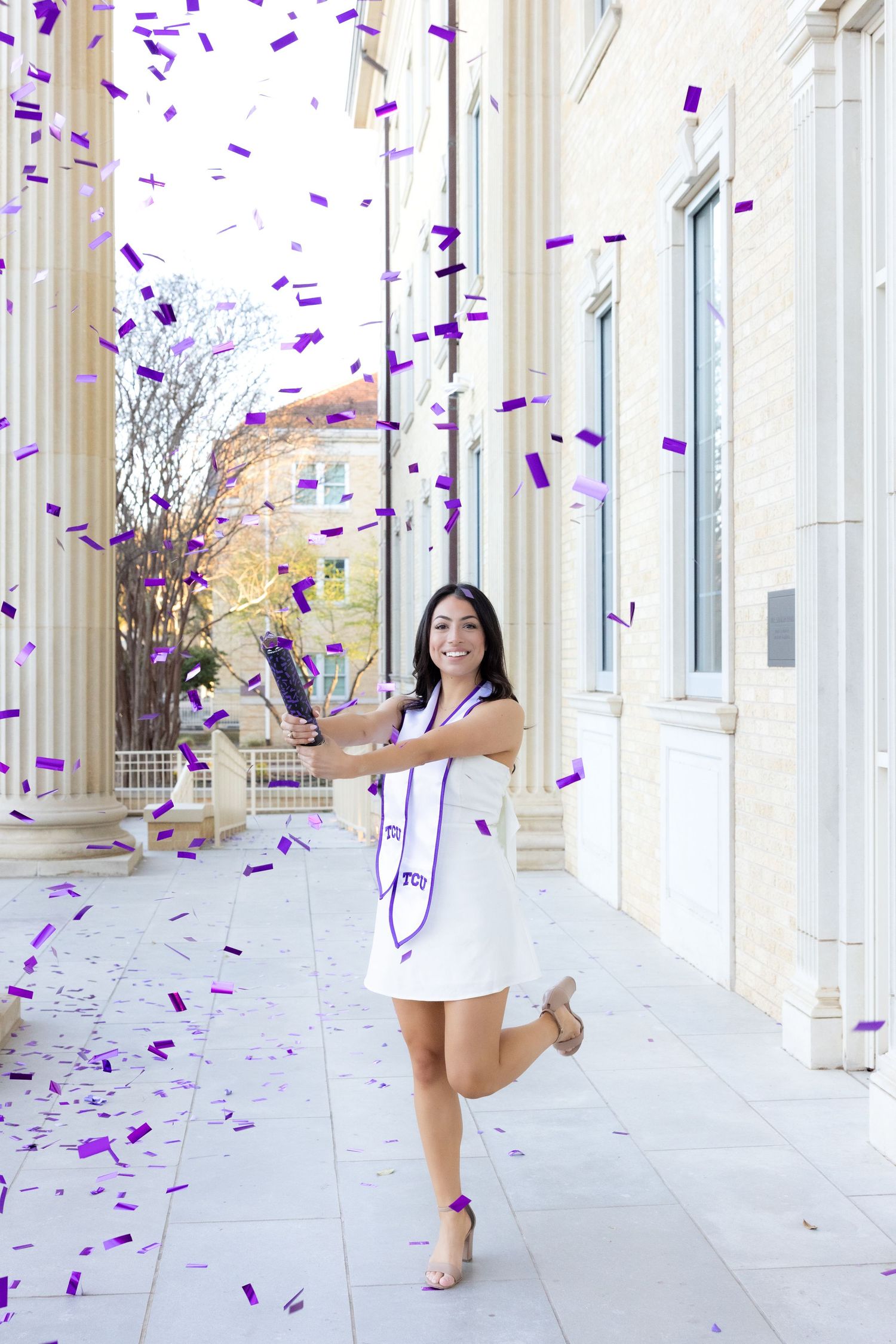 A senior at TCU taking senior photos in Fort Worth Texas.
