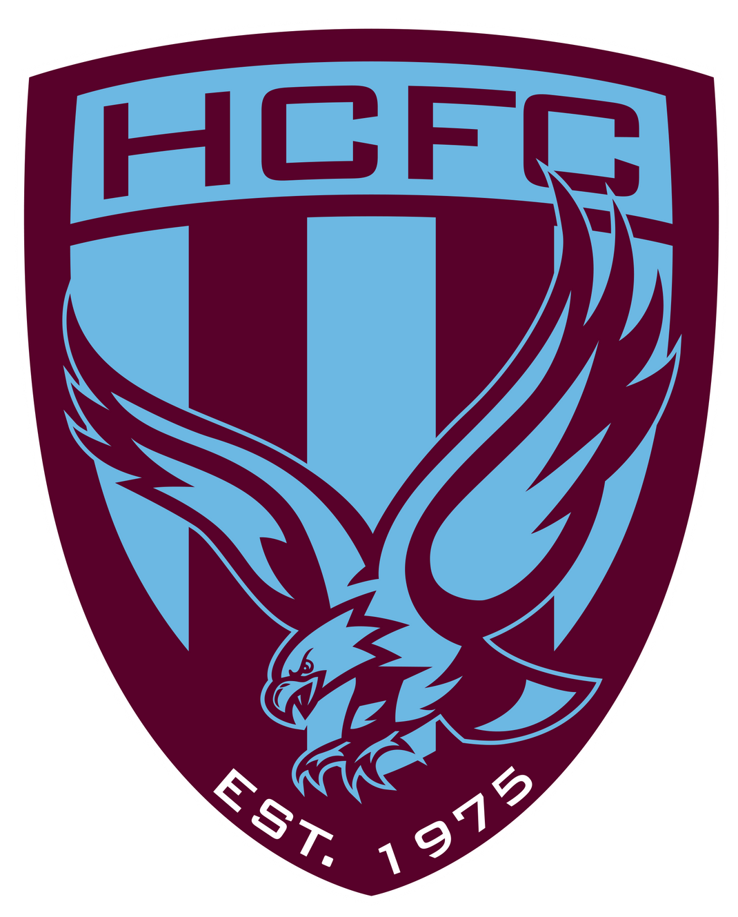 Purple and light blue soccer club crest featuring an eagle design and text reading HCFC EST. 1975.
