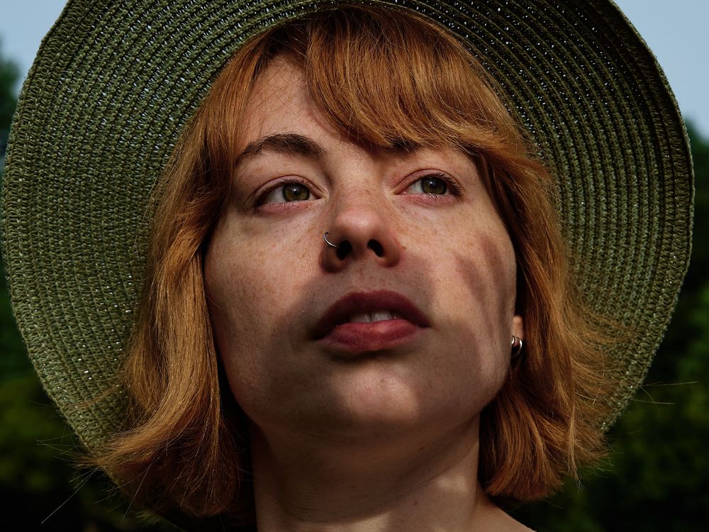 A series of playful expressions shown in a sequence of headshots with a green hat and red lipstick.