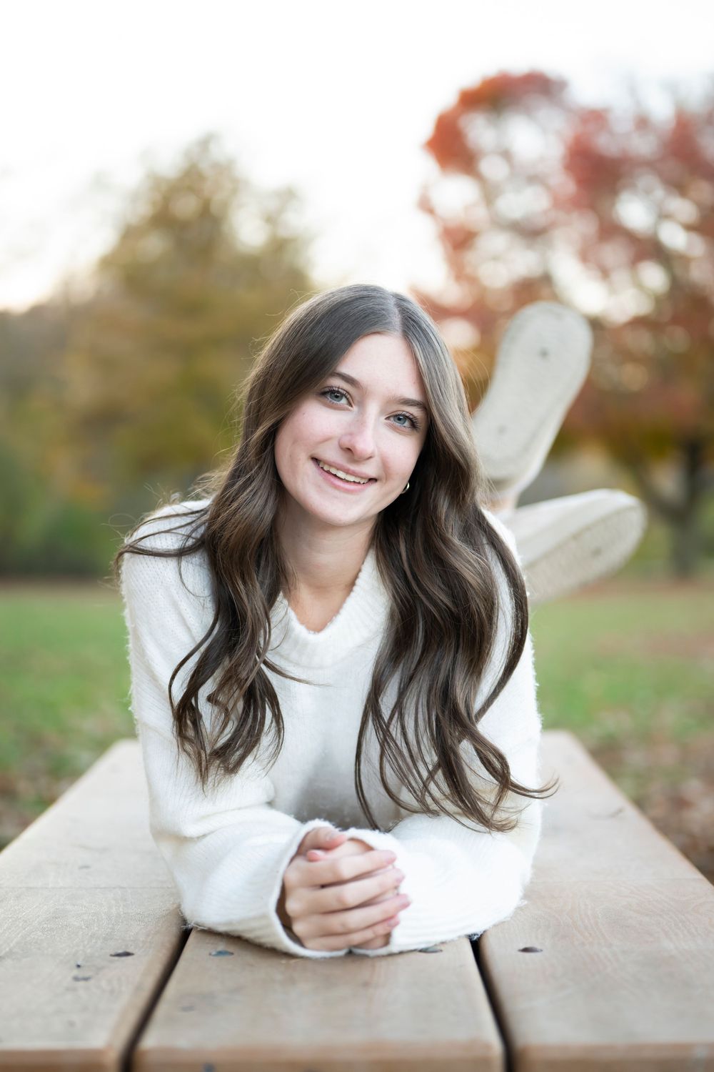 Relaxed portrait on wooden deck during autumn season.