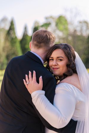 Intimate moment between newlyweds during their outdoor wedding photoshoot.