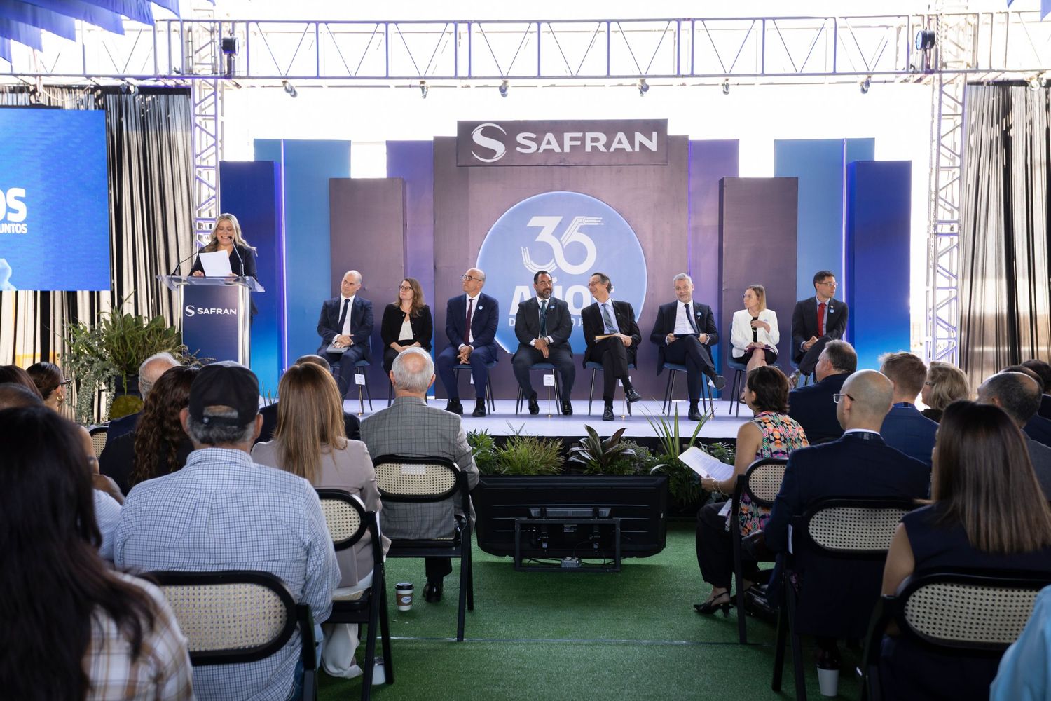 Safran 35th anniversary corporate event with executives on stage addressing seated audience at formal ceremony.