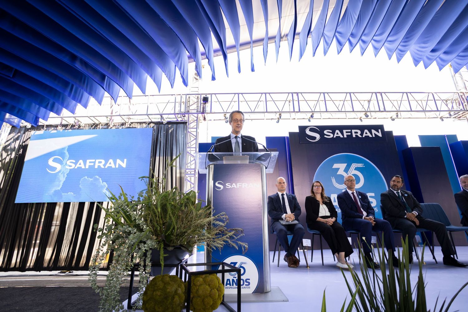 Safran executive delivers speech at podium during company's 35th anniversary corporate event with seated guests.