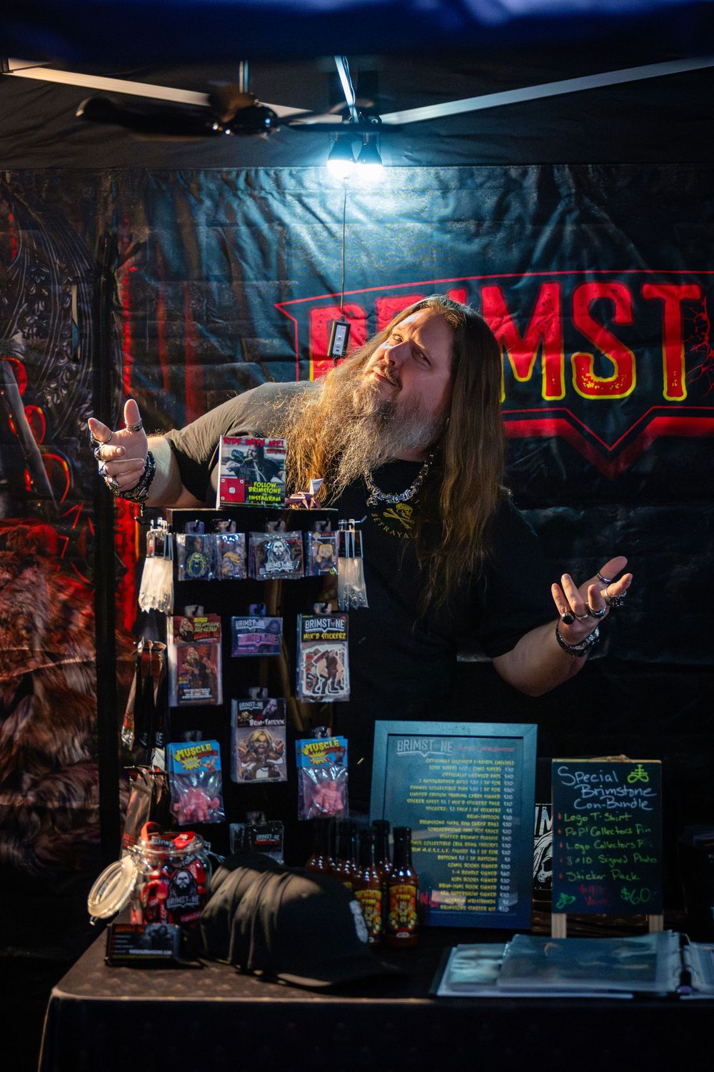 Dark nightclub interior with neon signage and posters displayed on walls showing an edgy underground performance space.