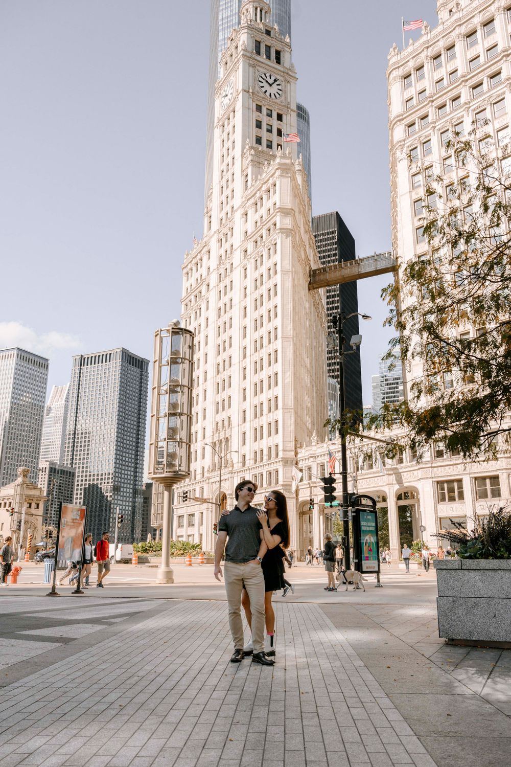 A couple exploring downtown Chicago streets surrounded by historic architectural landmarks and tall buildings.