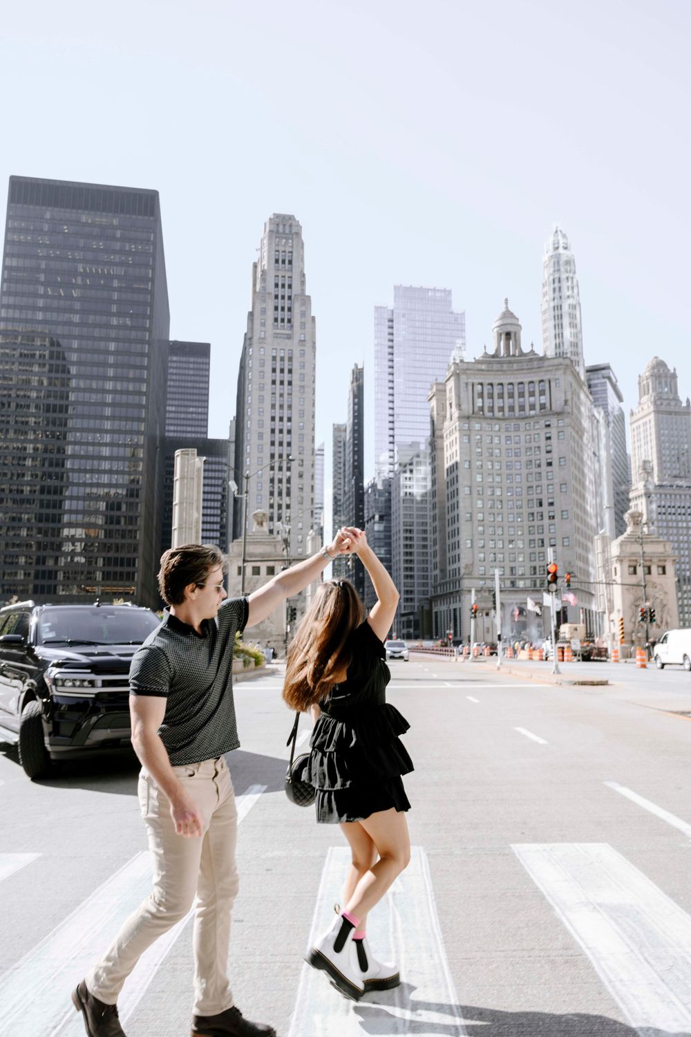 A romantic dance pose against the backdrop of downtown Chicago's iconic skyscrapers and urban architecture.