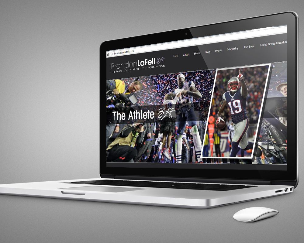 Multiple laptop displays showing responsive web design layouts on dark gray background.