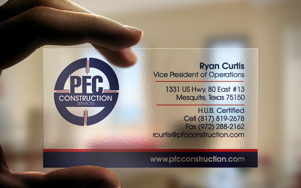 Close-up view of business cards showing contact information and company branding in a professional office setting.