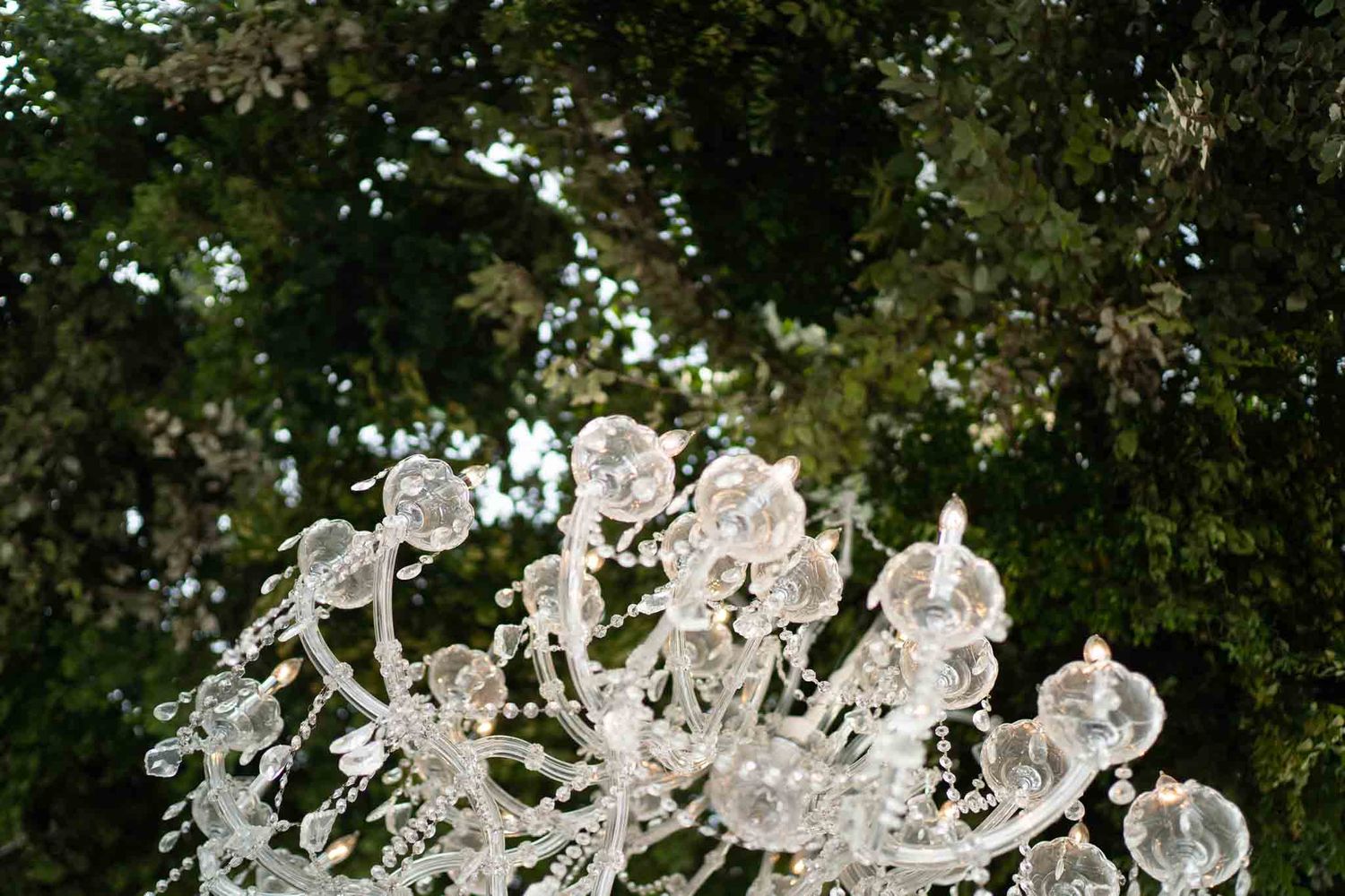 Angled photo of a chandelier capturing the atmosphere of a wedding venue
