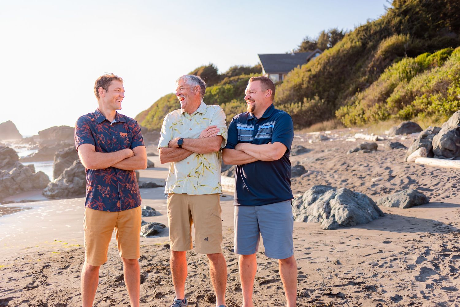 Men in the family share a laugh while getting their picture taken along Oregon's beautiful coastline.