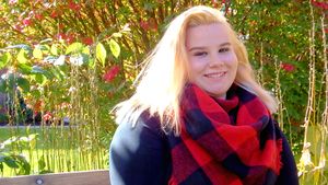 Fall outdoor portrait session featuring red plaid flannel and casual style against autumn foliage.