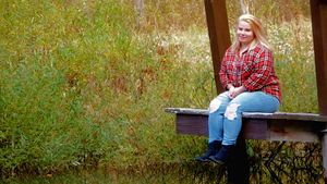 Casual outdoor portraits taken against fall foliage and natural scenery.