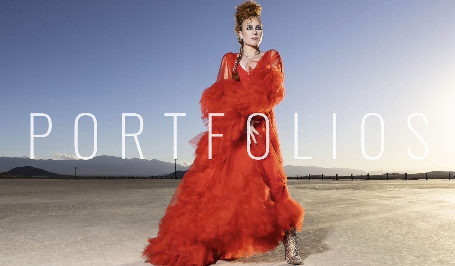 Female musician portrait Tarra Layne wearing red dress standing in desert