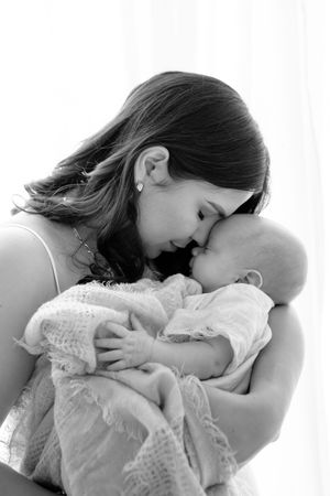 Three black and white images of a tender mother and child bonding moment showing gentle affection and closeness.