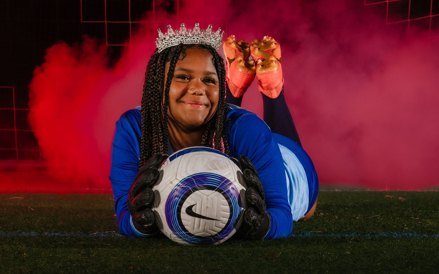 Parkland girls soccer goalkeeper Media Day portrait with crown and red smoke, by Deanna Fox, SportsFox Photography, Hershey PA