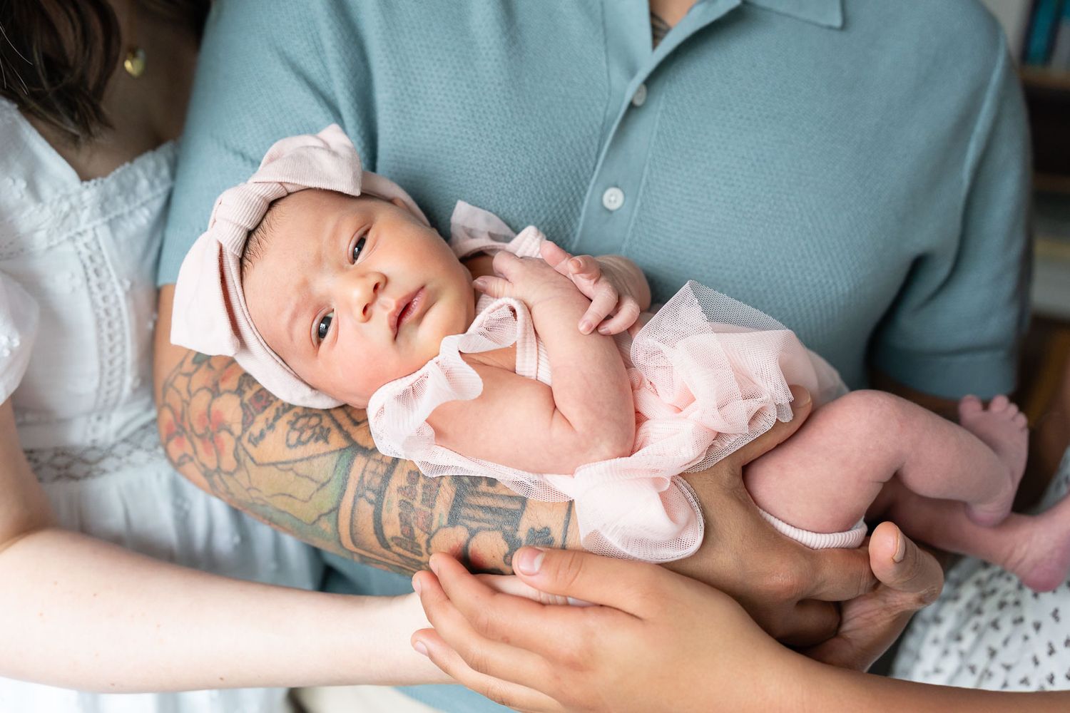 Family holding newborn.