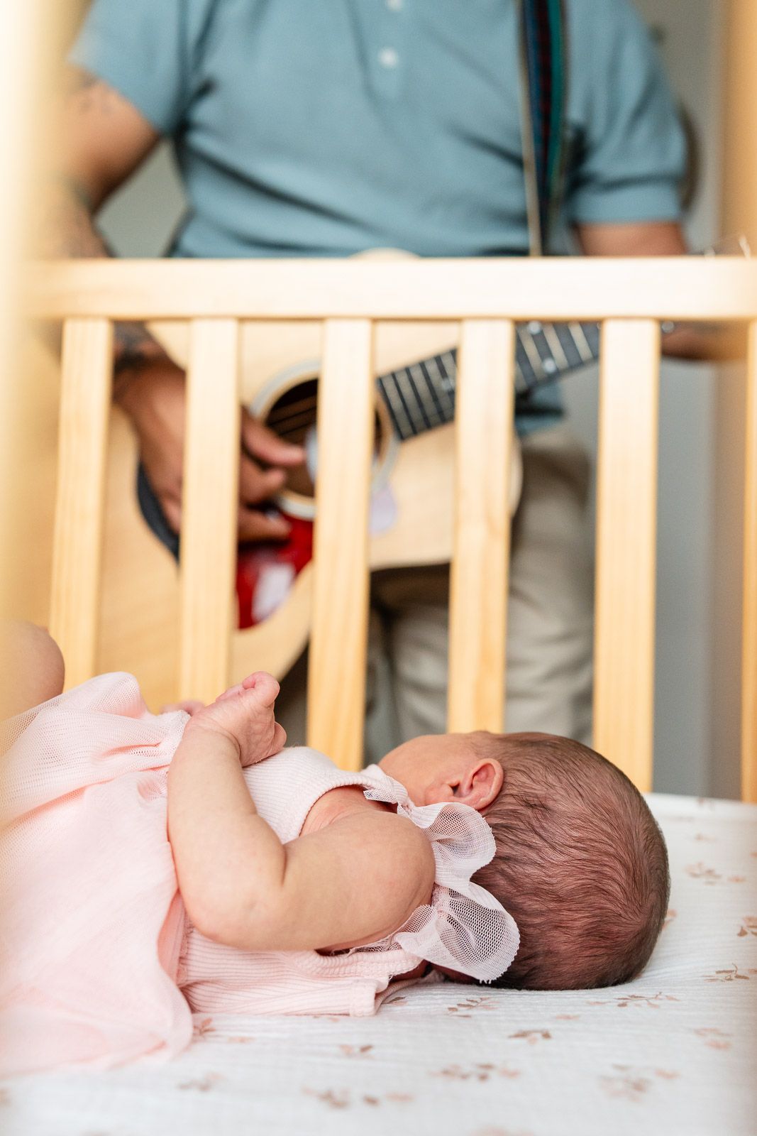 Dad playing guitar for baby.