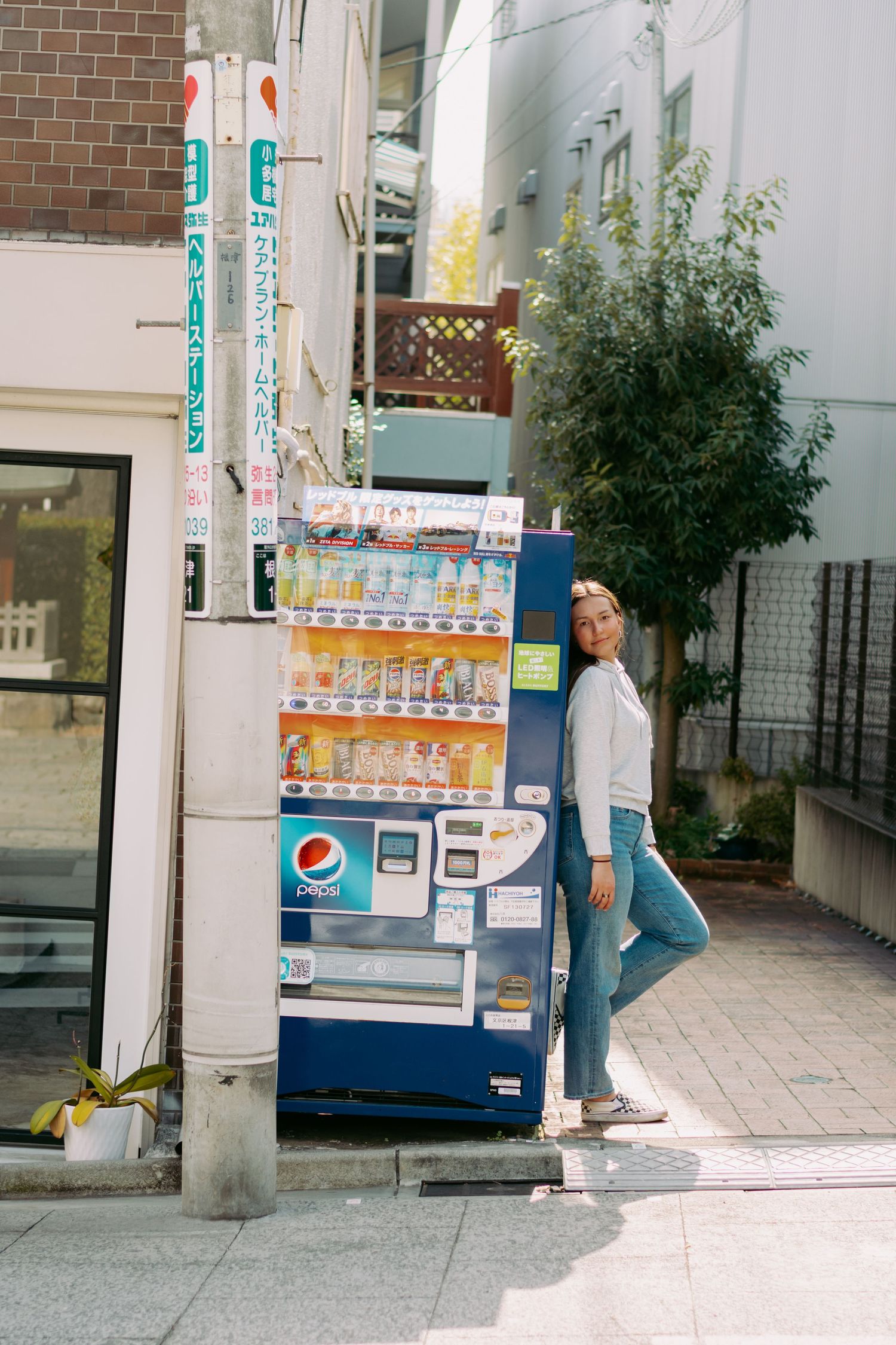 Creative fashion portrait in front of a Tokyo vending machine.