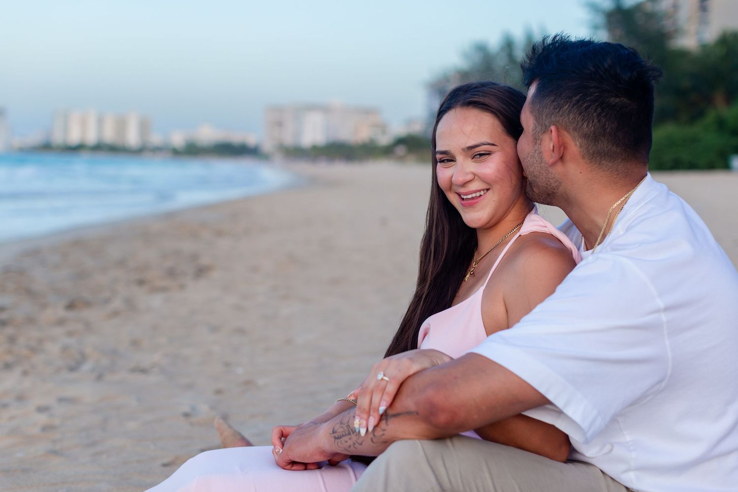 Couples portrait seated at the beach in Isla Verde, Carolina, Puerto Rico.