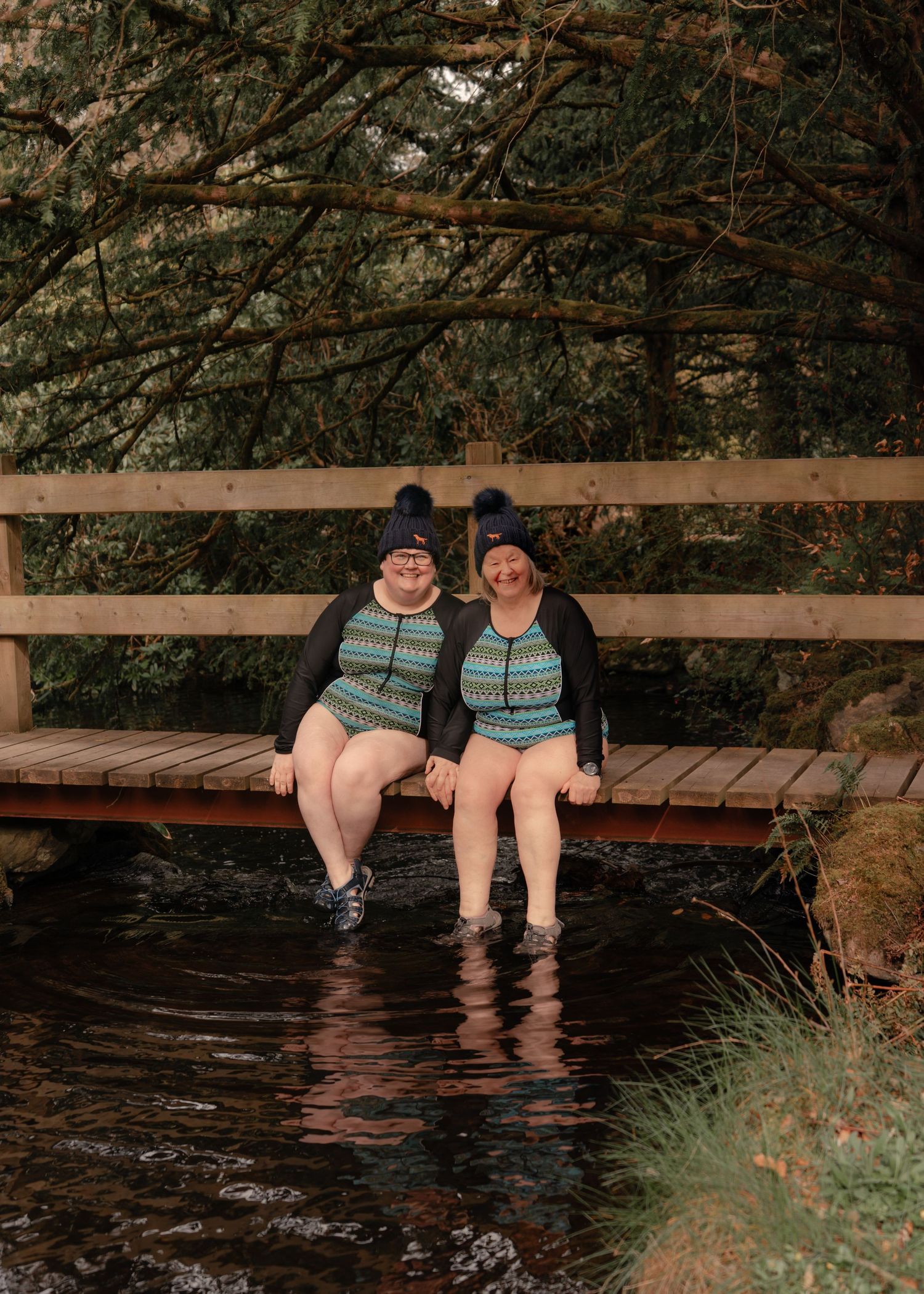 Couple participating in a wild swim during their elopement in the Scottish Borders captured by Scottish photographer